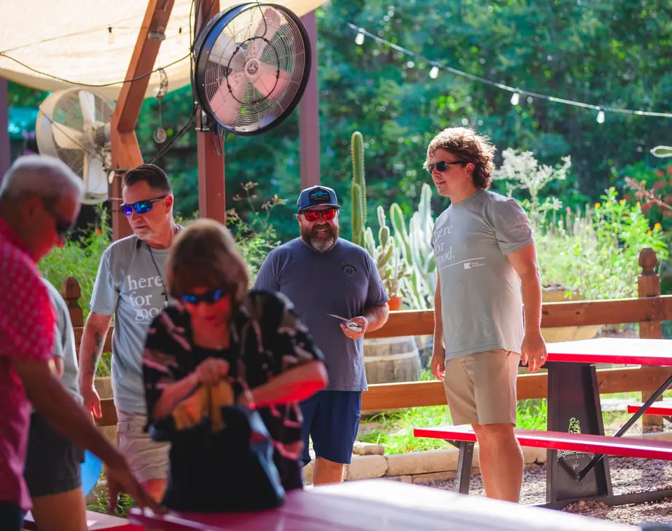 People gathered around picnic tables at an outdoor meal