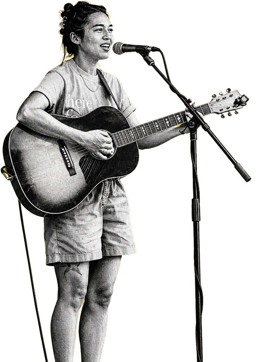 A woman singing and playing guitar at a King's Community gathering